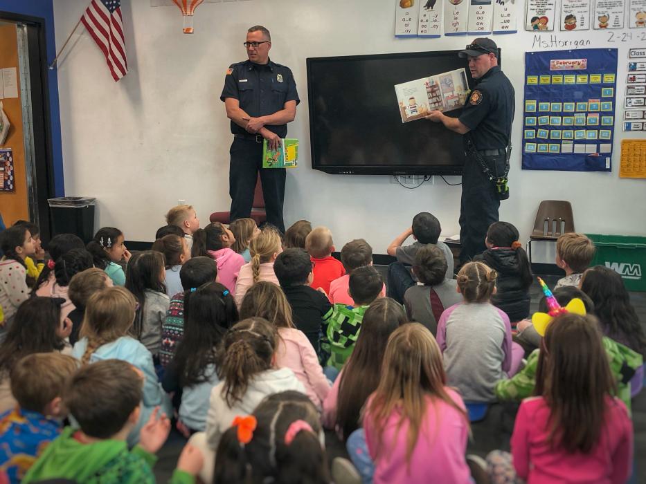 Members of the Carson City Fire Department read for students.