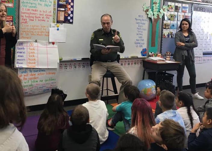 Carson City Sheriff Ken Furlong reads to students.