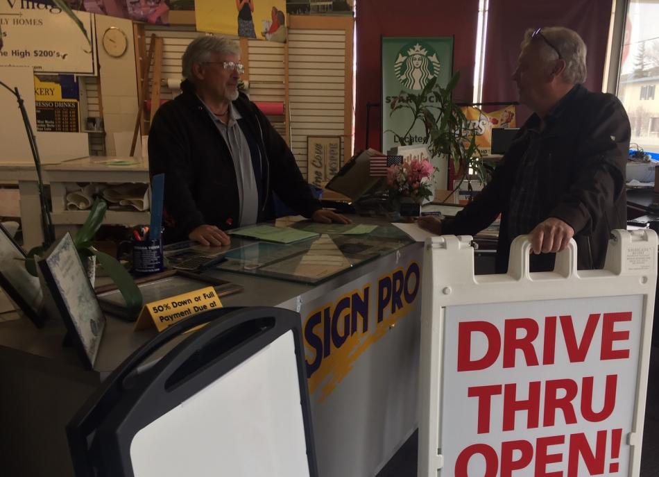 Steve Reynolds, Carson City Sign Pro owner speaks with Jack Brower who had a custom sign made.