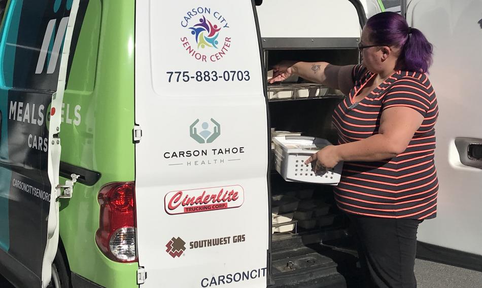 Meals on Wheels Driver, Amber Eaton, loads meals for the day.