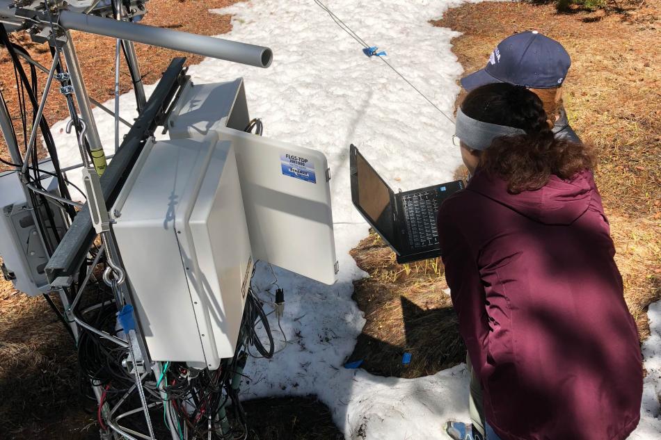 Photo by Adrian Harpold. UNR students perform maintenance on data-collection equipment.