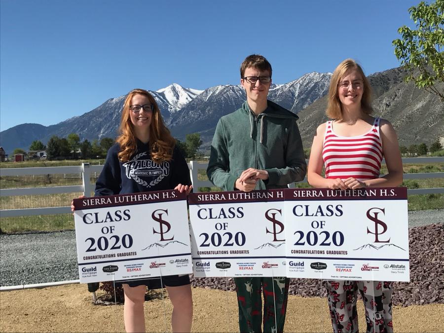 Siblings Jennifer, Carlton, and Emma Carnes awoke to a Saturday morning surprise delivery of signs to kick-off Graduation Week.