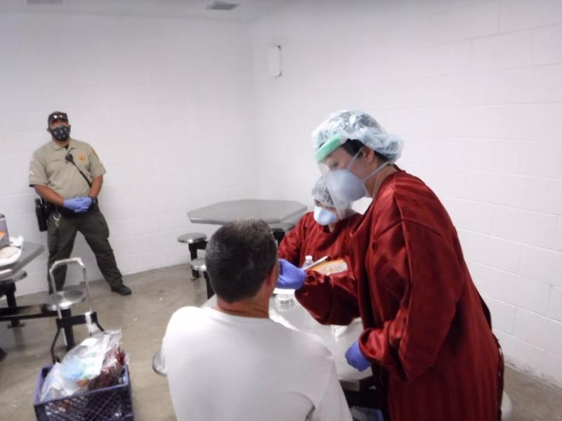 An NDOC nurse tests an offender for COVID-19