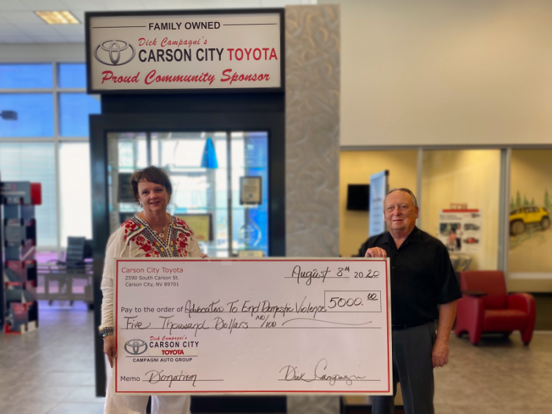 Advocates to End Domestic Violence accepts a check donation from Carson City Toyota.