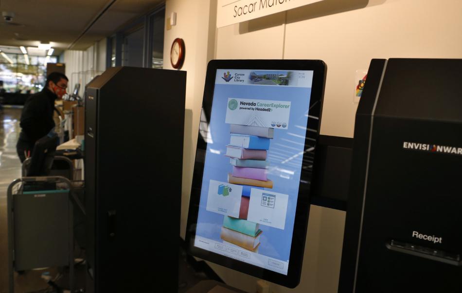 Carson City Library staff set up new self-check kiosks. Photo by Cathleen Allison, Nevada Momentum Fueled by RAD