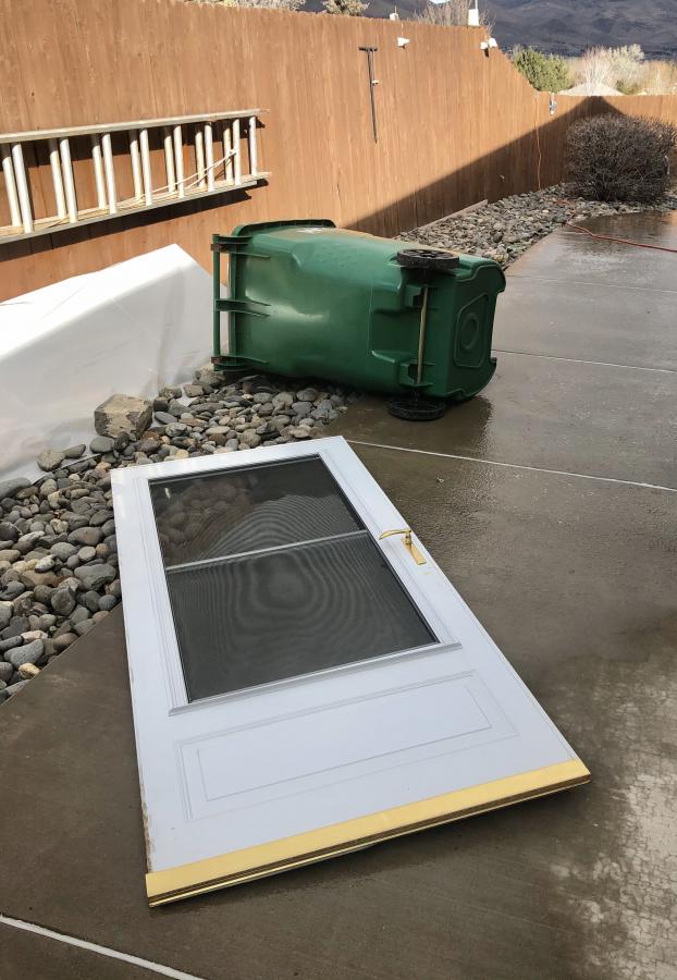 Storm door ripped from its hinges