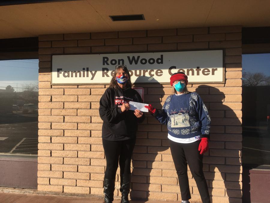 Joyce Buckingham of Toys for Tots accepts check from Casey Currie chair of Democratic Women's Club