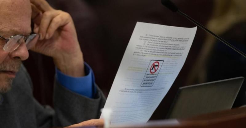 Assemblyman Jim Wheeler reads an amended copy of SB 452. (David Calvert/The Nevada Independent)