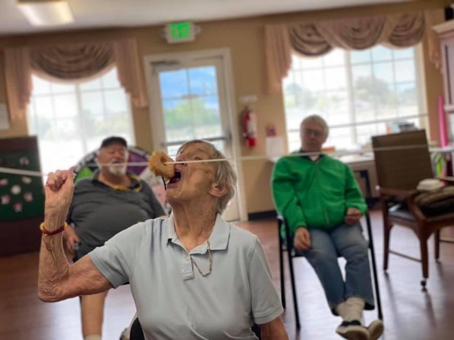 Susan Rielley participates in Carson Valley Senior Living's Olympic donut eating contest.