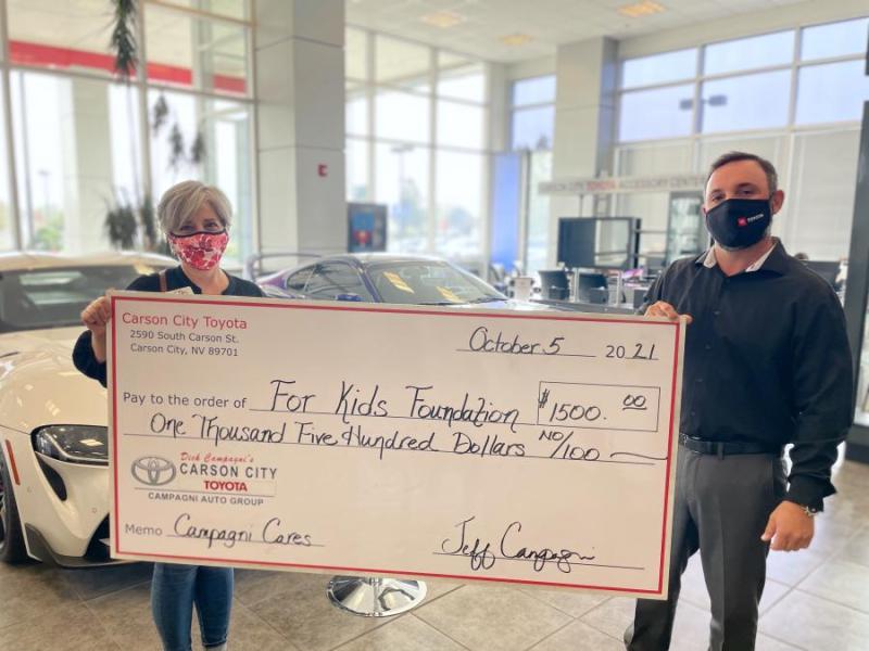 General Manager of Carson City Toyota, Jeff Campagni, presents a check to For Ki
