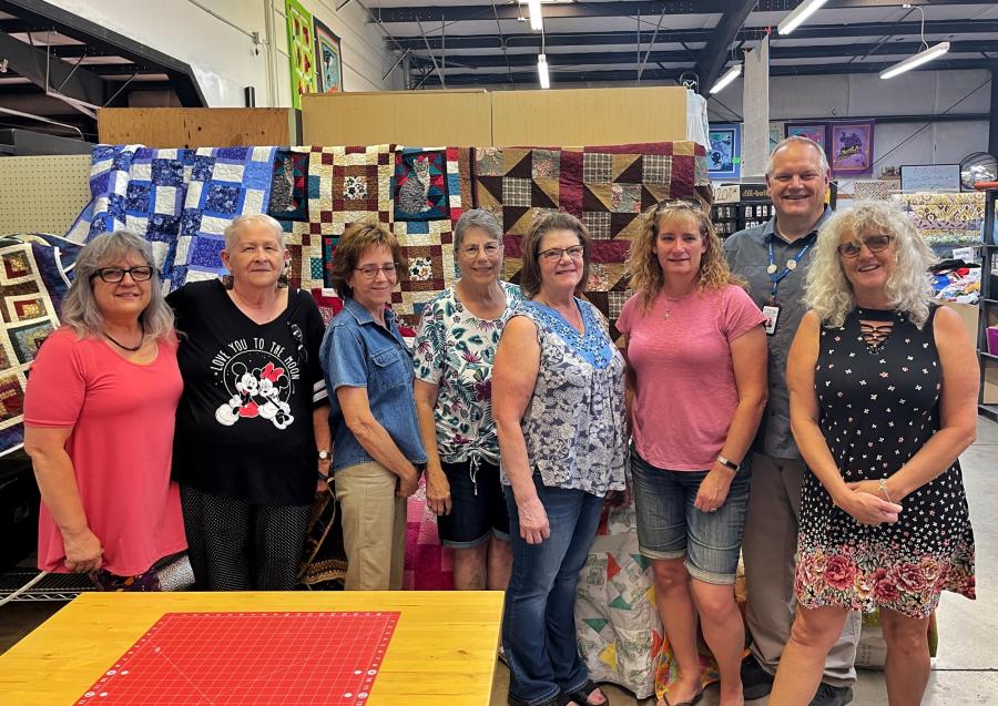 Greg, Director of Visiting Angels of Carson City, with members of Ditch Stitcher Quilt and Sewing Group