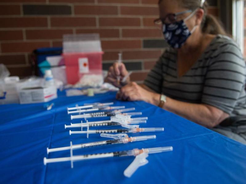 COVID-19 vaccines are loaded into syringes inside the Joe Crowley Student Union. David Calvert/The Nevada Independent