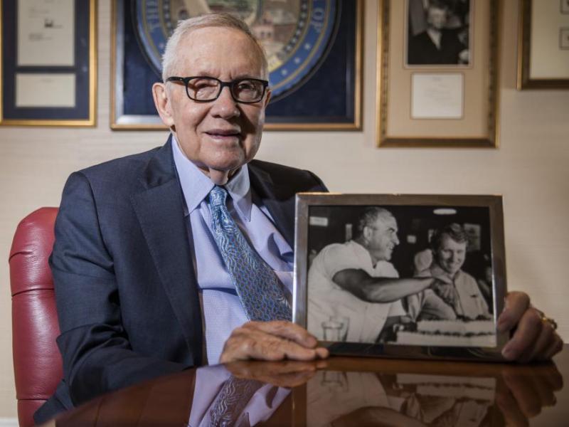 Former Senate Majority Leader Harry Reid holds a photo of him with former Gov. Mike O'Callaghan. Jeff Scheid/Nevada Independent