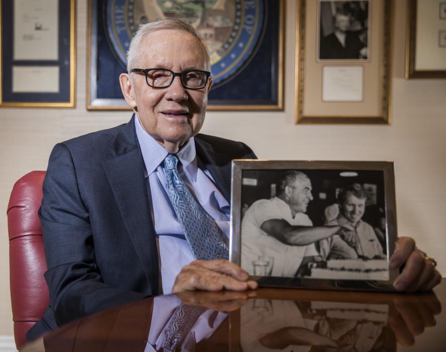 Former Senate Majority Leader Harry Reid holds a photo of him with former Gov. Mike O'Callaghan. Jeff Scheid/Nevada Independent
