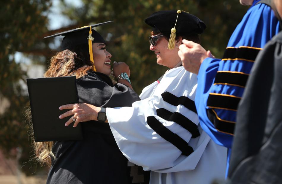 Nevada System of Higher Education Regent Carol Del Carlo, right, congratulates WNC graduate Danielle Blackwater.