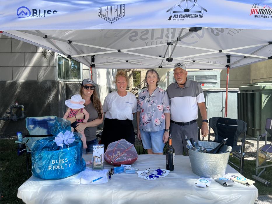 Volunteers at “Bliss Reality” get together on a hot day to serve the wine walkers.