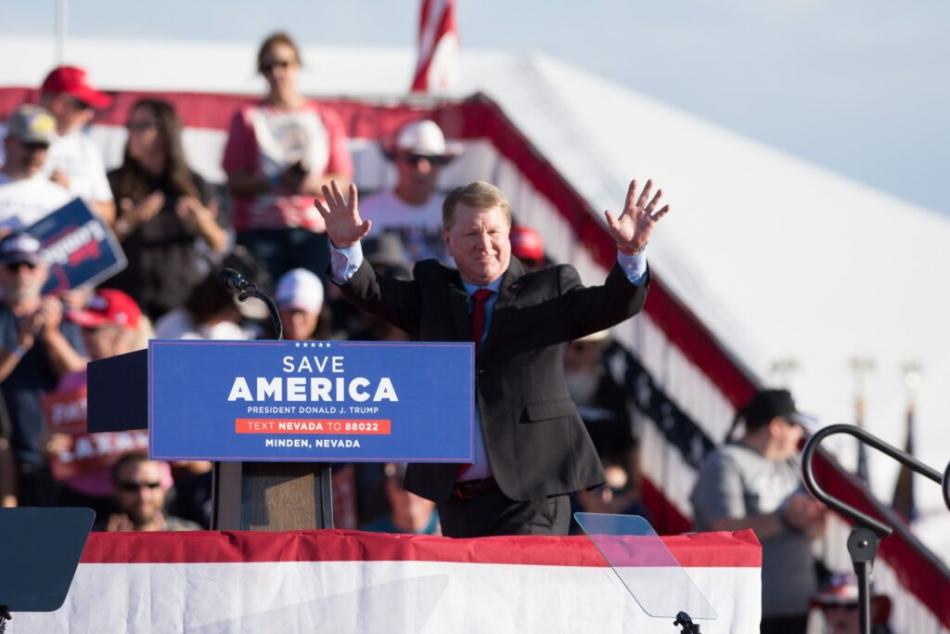 Republican secretary of state candidate Jim Marchant waves to the crowd during a 
