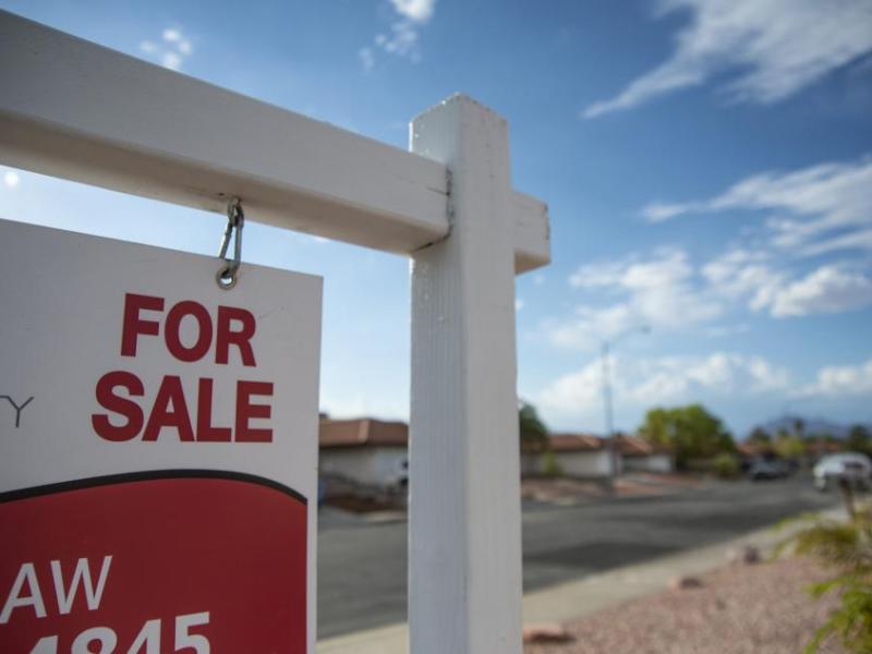A for sale sign outside a home listed for sale.