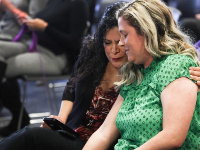 Marie Neisess, left, hugs school teacher Jessica Jones after she testified. (Jeff Scheid/The Nevada Independent)