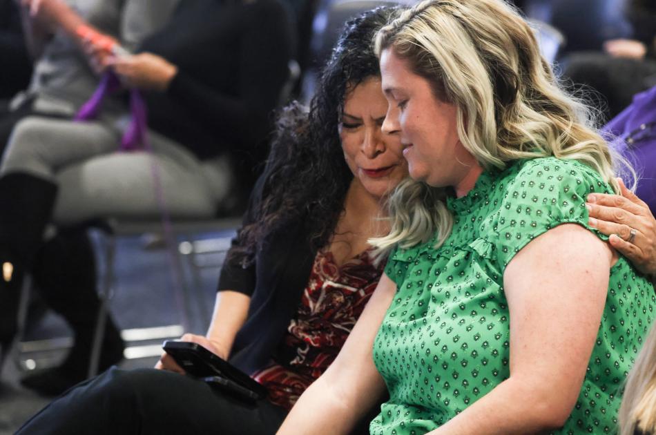 Marie Neisess, left, hugs school teacher Jessica Jones after she testified. (Jeff Scheid/The Nevada Independent)