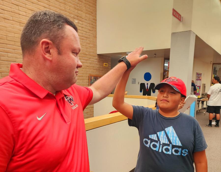 Greg Thetford, vice principal of Eagle Valley Middle School and student do a High 5.