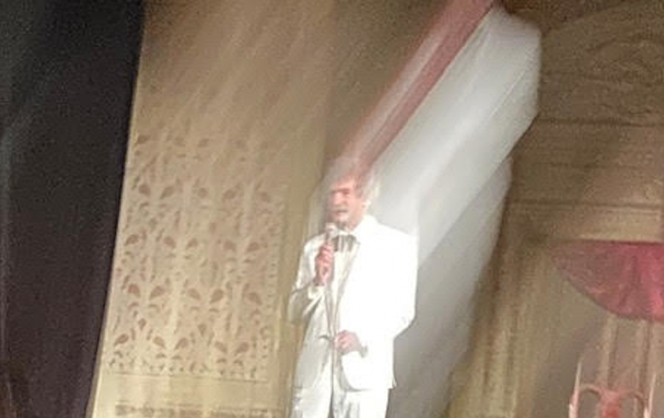 McAvoy as Mark Twain tells a story under the lights.