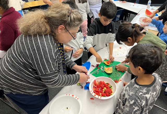 Students collect seeds from various fruits.
