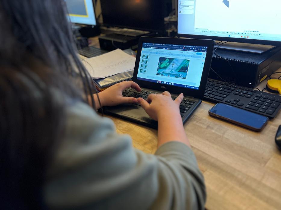 Engineering students work on software during class.