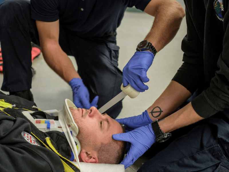 WNC students practice skills on instructor Josh Wilcox during an EMS class.