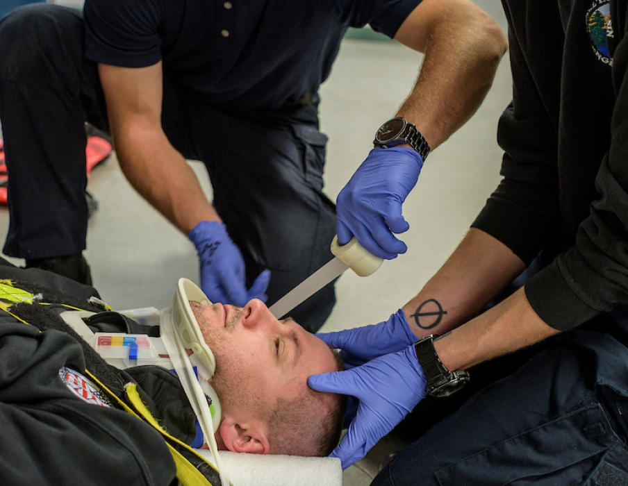 WNC students practice skills on instructor Josh Wilcox during an EMS class.