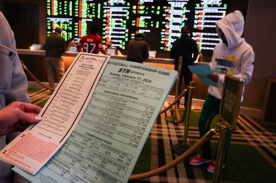 A customer views Super Bowl LVIII proposition wagers and parlay bets at the Durango Casino sportsbook. Photo by Jeff Scheid