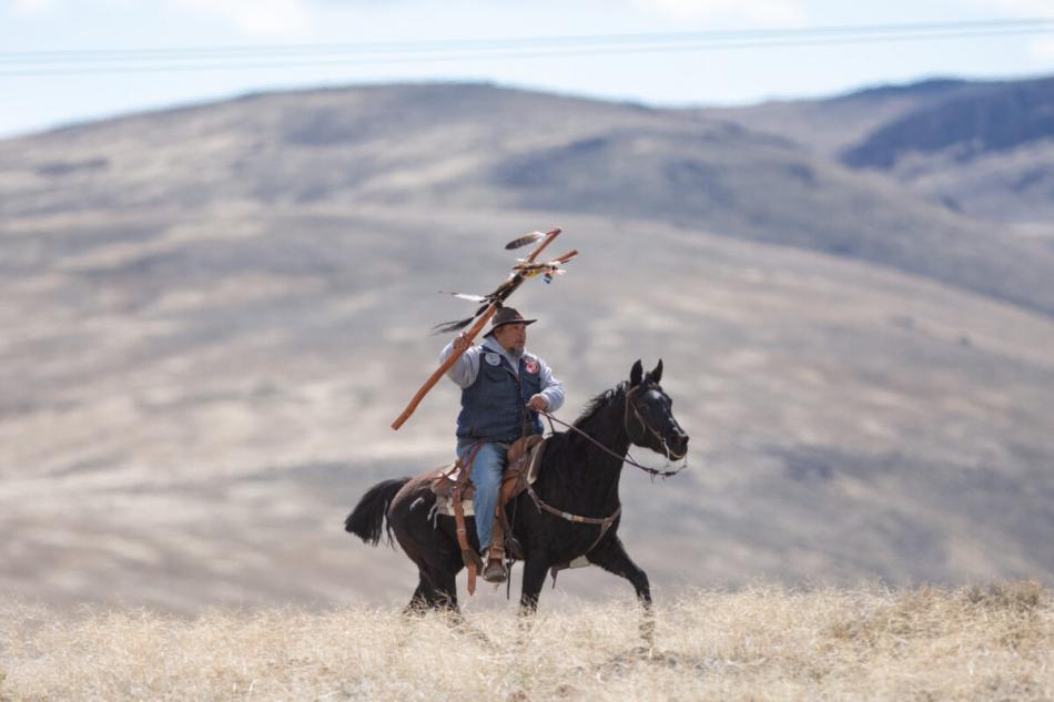 Prayer horse ride co-founder Josh Dini summits the southern end of the McDermitt Caldera at Sentinel Rock