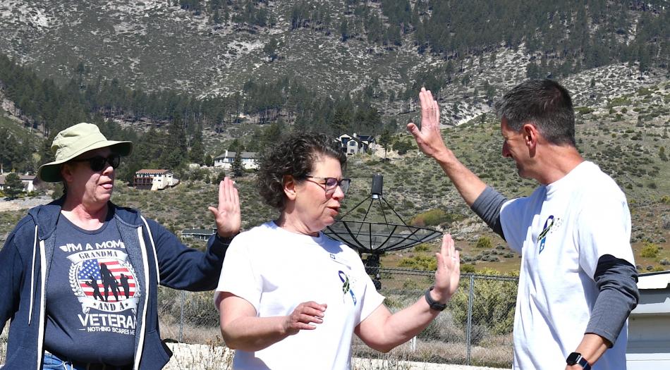 Western Nevada College President Dr. J. Kyle Dalpe high-fives participants in the Walk for Hope on Wednesday.