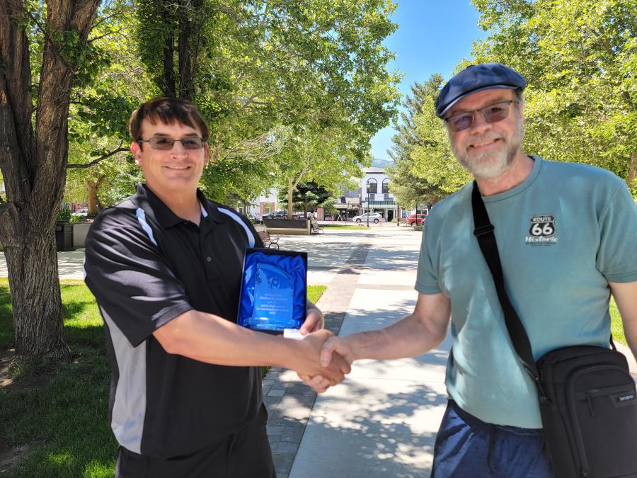 Carson City author Michael K. Falciani, left, receives the ACES High Award from