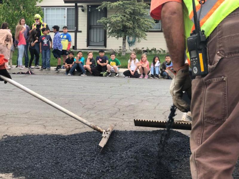 Students observe Carson City Public Work employees fixing pot holes
